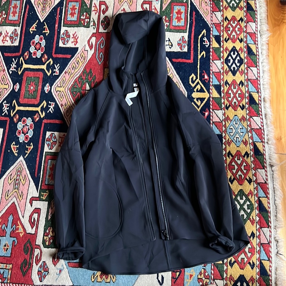 Hooded jacket. Hits at or just below hips. Loose fit.